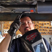 Tommy Hernandez works under a car